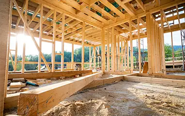 Timber framing of a new house build in sunlight