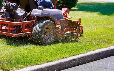 Zero-turn mower cutting a green lawn
