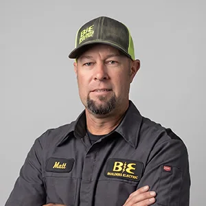 Studio portrait of a Builder's Electric team member in a branded shirt