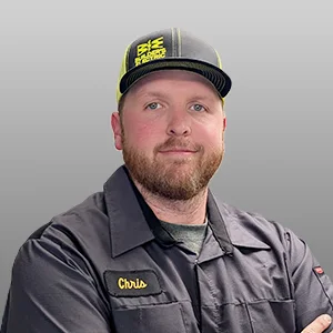 Studio portrait of a Builder's Electric team member in a branded shirt