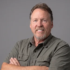 Studio portrait of a Builder's Electric team member in a branded shirt